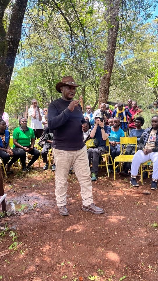 Rotarian addressing participants at Mang'u High School tree planting event
